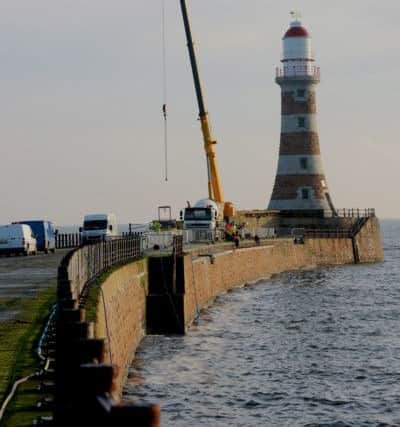 A crane was drafted in as part of the kit used to recover coping stones from the sea off Roker Pier.