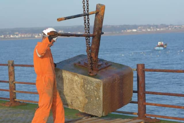 One of the coping stones is lowered by a crane after it was saved by the sea off Roker Pier.
