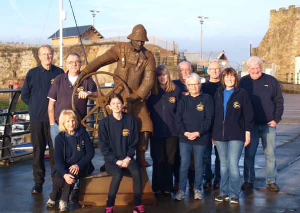 Members of East Durham Heritage Group next to The Coxwain, an artwork created by Ray Lonsdale.
