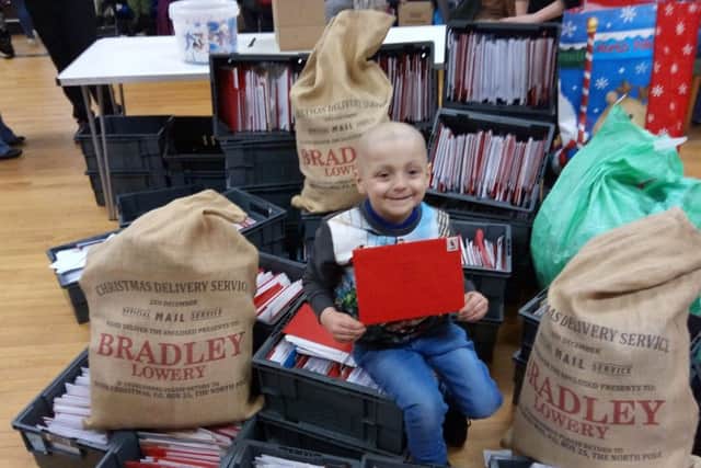 Bradley Lowery helps with the opening of his Christmas cards