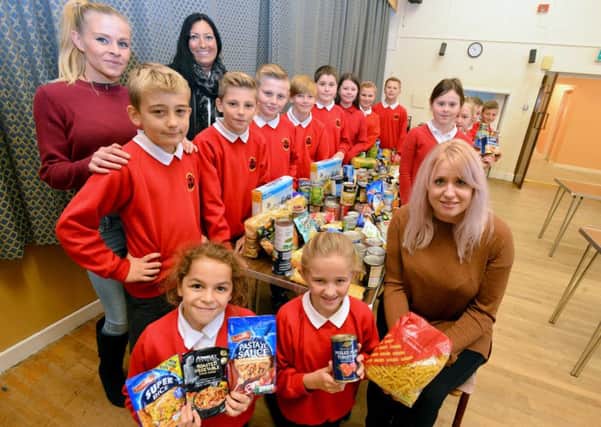 Barnwell Primary School pupils donated food to Penshaw Clothing Bank, pictured with organiser Katherine Mason.