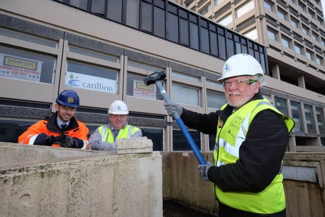 Ben Harris, of Thompsons of Prudhoe, and Steve Hunter, of Carillion, look on as David Glencorse starts the demolition of Milburngate House. Picture by Keith Taylor.