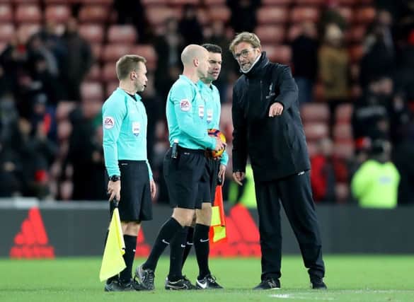 Liverpool manager Jurgen Klopp speaks with match referee Anthony Taylor at the end of the game