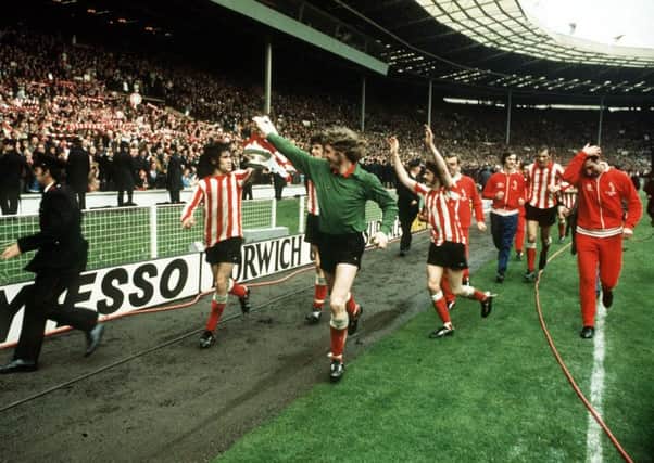 Billy Hughes and Jim Montgomery hold the FA Cup as they circuit the pitch after Sunderland beat Leeds in 1973
