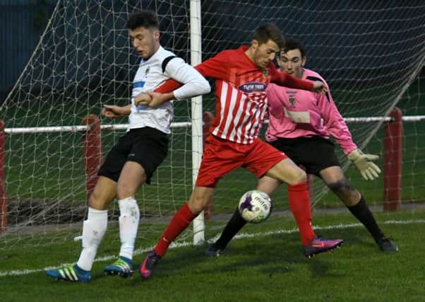 Ryhope CW (red) threaten the Consett goal in last month's Northern League Division One clash.