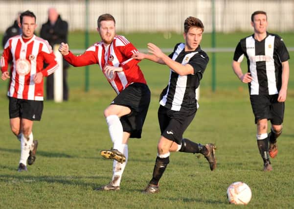 Sunderland West End (red and white) battle against Wearside League rivals Boldon CA in the Shipowners' Cup last month