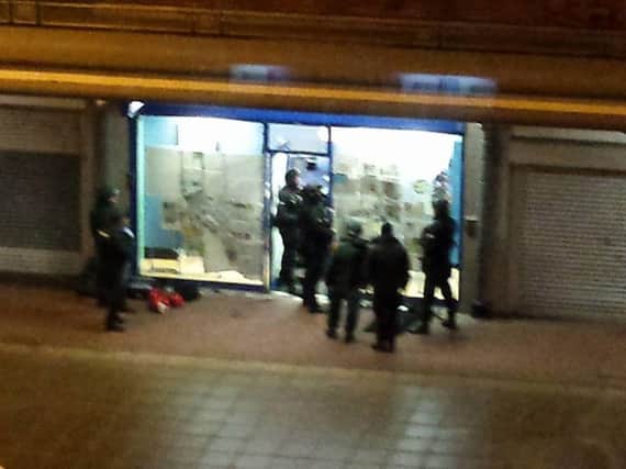 Police outside the Coral bookmaker in Jarrow on Sunday night. Picture by Stephen Dixon.