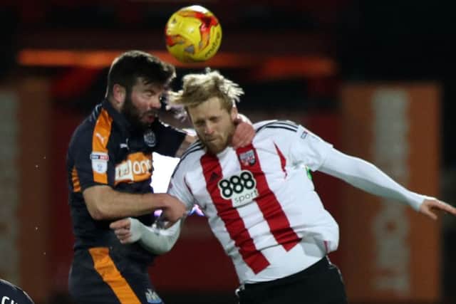 Newcastle defender Grant Hanley (left) battles against Philipp Hoffman at Brentford