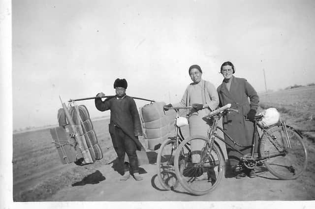 Marion Young and her colleague Wang Ssu Wen with the man carrying their luggage.