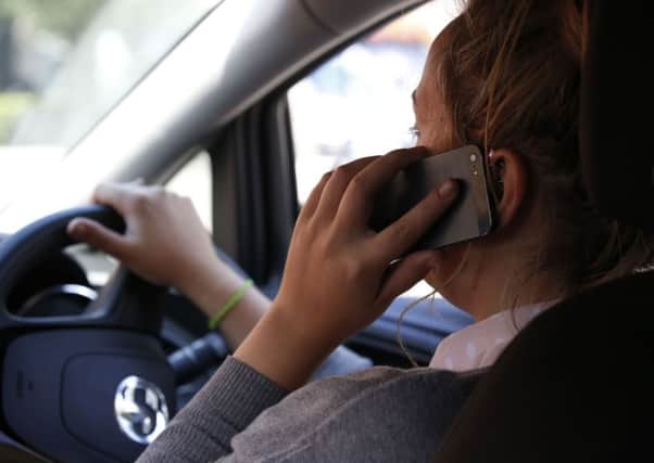 Police are clamping down on drivers who use their mobile behind the wheel