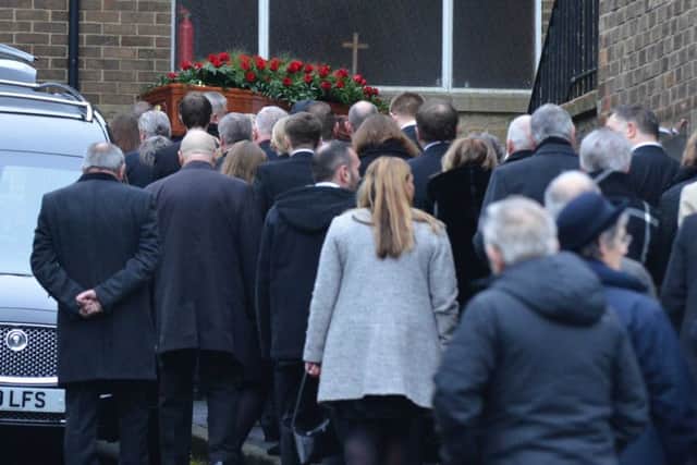 Mourners attending the funeral of John Cummings.