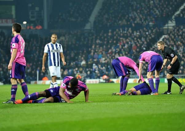 Anichebe and Denayer both go down hurt in today's defeat. Picture by Frank Reid