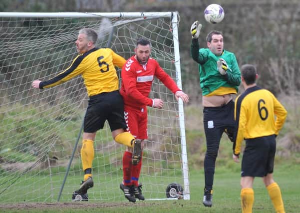 Wearmouth CW (red) take on Penshaw Catholic Club in last week's Premier Division clash. Picture by  Tim Richardson