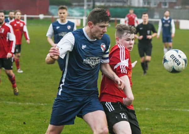 Sunderland RCA's James Cassidy (red) battles against Shildon last week. Picture by Kevin Brady