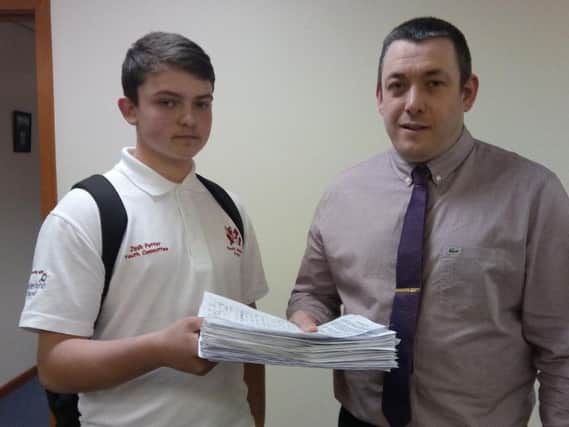 Josh Potter hands the petition to Coun Phil Tye