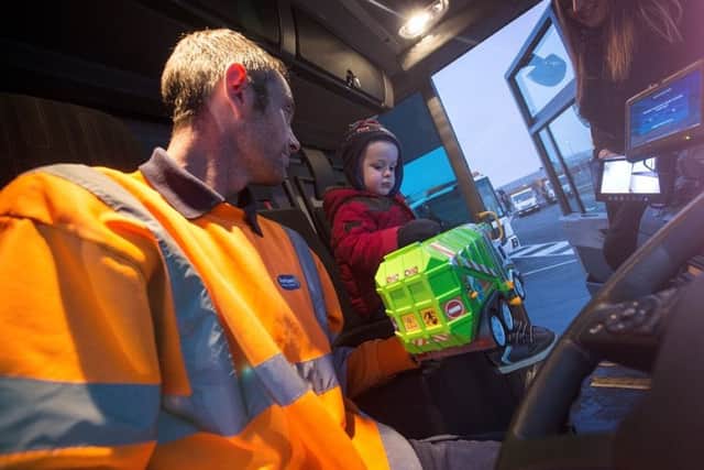 Bin lorry driver Paul Hardy with two-year-old Jack Beswick.