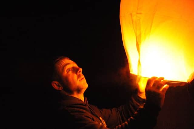 Amber Cliff's brother Josh releasing a lantern at Roker.