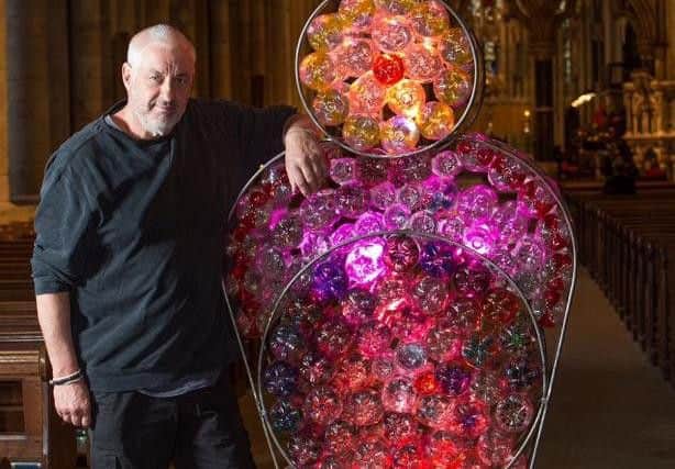Mick Stephenson with a section of his recreation of Durham Cathedral's Rose Window using plastic bottles, put on show during last year's Lumiere. He got involved after first taking part in Brilliant at an earlier festival.