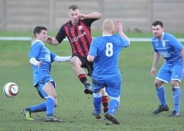 Ashbrooke Belford House (red and black) battle against Seaham Red Star Reserves in the Wearside League last week. Picture by Tim Richardson
