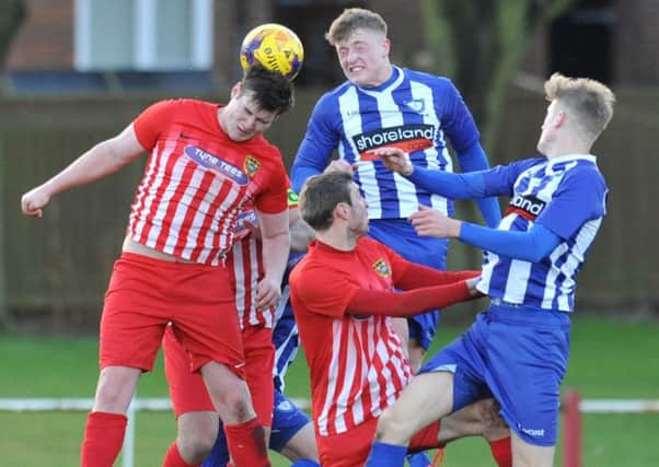 Ryhope CW (red) battle against Whitley Bay in last week's epic 4-4 First Division draw. Picture by Tim Richardson