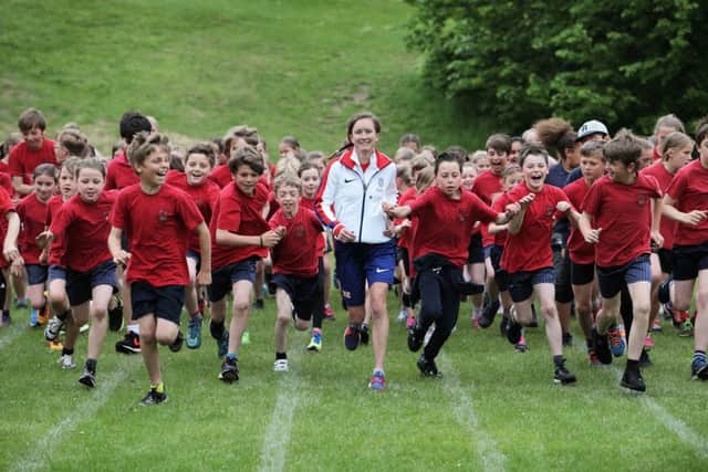 Sunderland runner Aly Dixon taking part in the 'Run to Rio' campaign to raise funds for St Benedict's Hospice in Sunderland, at St Margaret's Primary School in Durham.