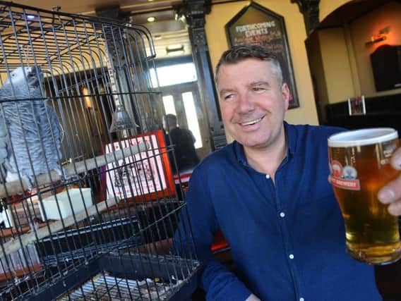 Stefan Emmerson with Kings Arm pub parrot Peter