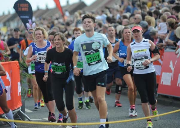 Great North Run runners approach the race finish line in South Shields.