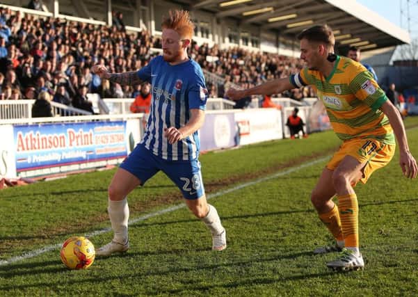 Hartlepool debutant Louis Rooney takes on Yeovil's Ryan Dickson.  Picture by Tom Banks