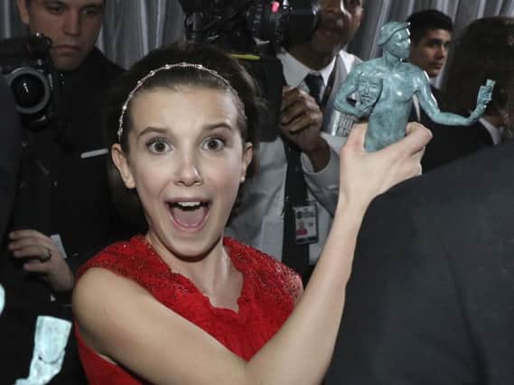Millie Bobby Brown with the award for outstanding performance by an ensemble in a drama series for Stranger Things at the Screen Actors Guild Awards. Picture: Matt Sayles/Invision/AP.