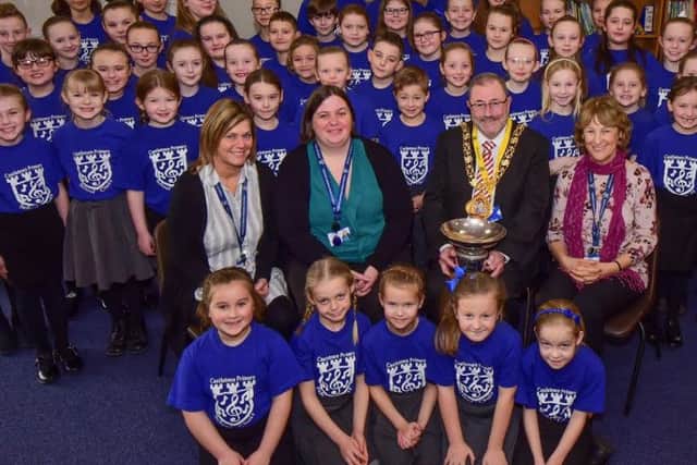 The Mayor of Sunderland Councillor Alan Emerson presenting the Dr. Gilbert Trophy to the City Sings winners, Castletown Primary School received by Gwen Ebdon, assistant, Caoimhe Nichomhrai, choir director, and head teacher Joan Lumsdon (right).