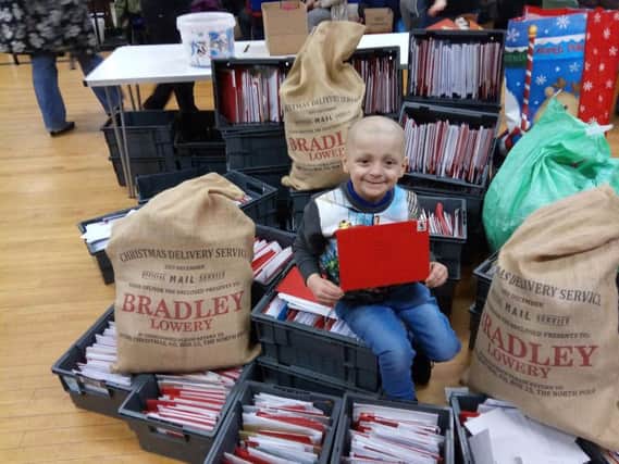 Bradley Lowery with some of the thousands of Christmas cards he received.