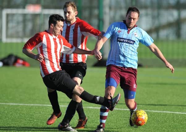 Lakeside (stripes) take on Hendon Athletic in a recent league clash. Picture by Tim Richardson