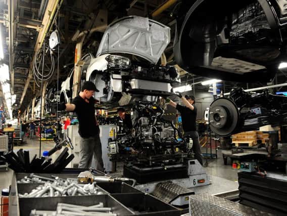 Employees at Nissan working on the Qashqai in Sunderland, as the car maker saw earnings slip into reverse in the third quarter despite notching up strong sales in the US, China and Europe. Picture by PA