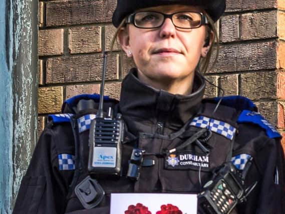 PCSO Natasha Bree holding a Valentine's card police will send to known shoplifters with the advice they should spend the day with "your loved one, not us"