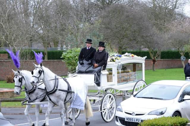 The funeral procession was led by a horse-drawn carriage.