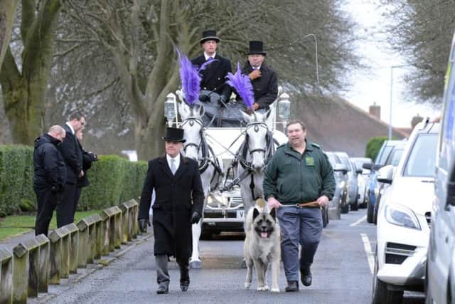 The funeral procession for Michael Doda, led by his dog Simba.
