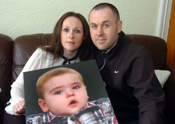 Darren and Janine Fucile with a photo of their late son Joseph Fucile, who they set up a fund for sick youngsters in memory of.