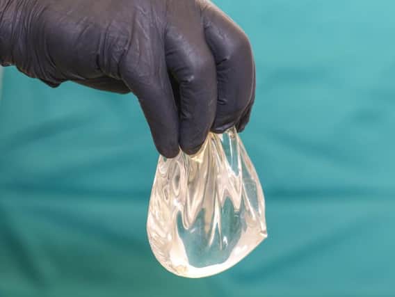 A doctor holds a silicone breast implant. Pic: Shutterstock.