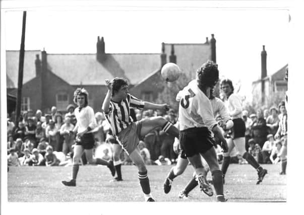 Easington player Barry Jones (stripes), in action.