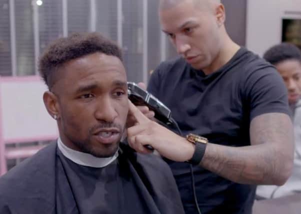 Jermain Defoe has his hair cut by Daniel Johnson.
