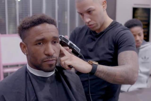 Jermain Defoe gets his hair cut by Daniel Johnson.