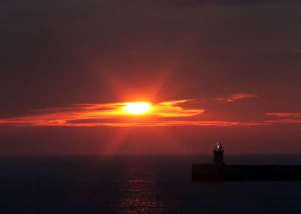 Dawn at South Shields lighthouse as the sun rises above the horizon. Picture: Owen Humphreys/PA Wire