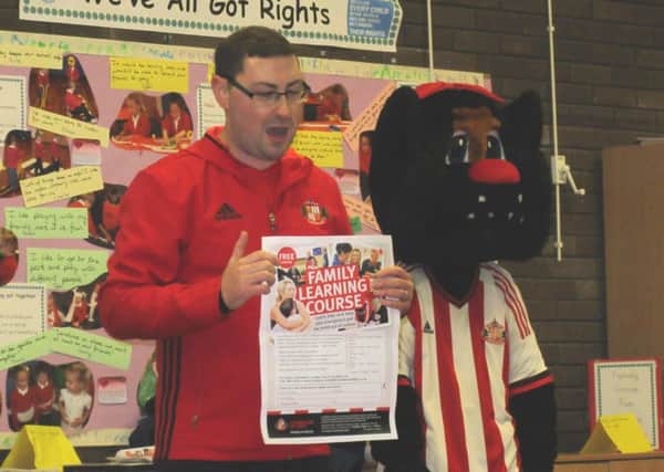 Sunderland AFC mascot Delilah is introduced to the pupils at Cotsford Infants School by a member of the Foundation of Light.