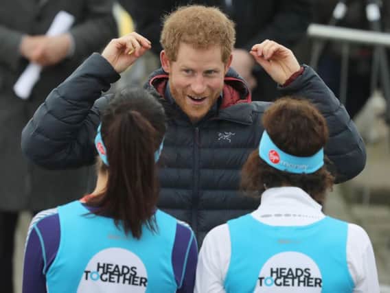 Prince Harry chats to runners during today's London Marathon warm up in the North East.