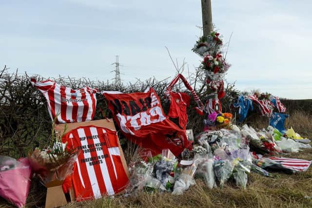 Flowers and cards placed in memory of Stuart Price at the scene of the RTA .