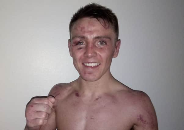 Bruised Jay Harris celebrates his win over Thomas Essomba last night