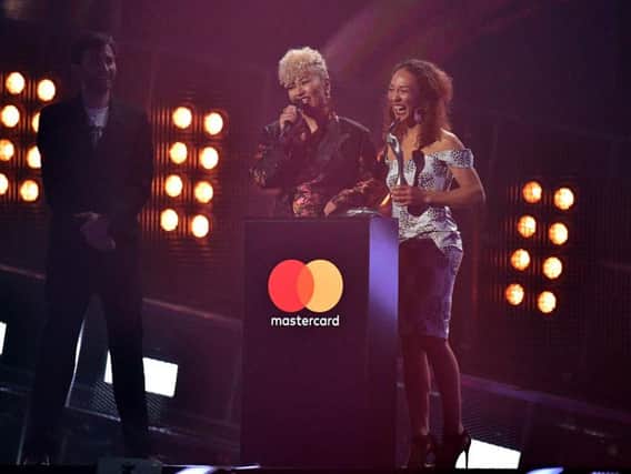 Emeli Sande and sister Lucy on stage at the Brit Awards at the O2 Arena, London, after the singer was presented with the title for Best British Female Solo Artist by David Tennant. Photo by Press Association.