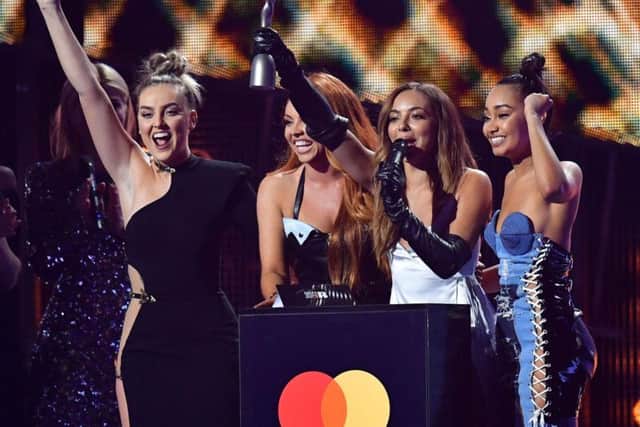 Little Mix receiving their Brit Award at the O2 in London. Pic: PA.