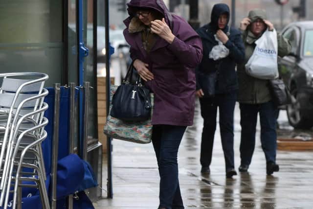 Shoppers battle against the wind and rain in Sunderland as Storm Doris makes her presence felt.