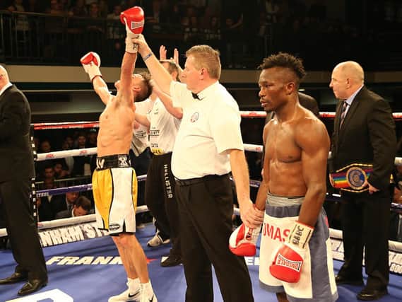 Referee Marcus McDonnell lifts the arm of winner Jay Harris. Picture by NATALIE MAYHEW